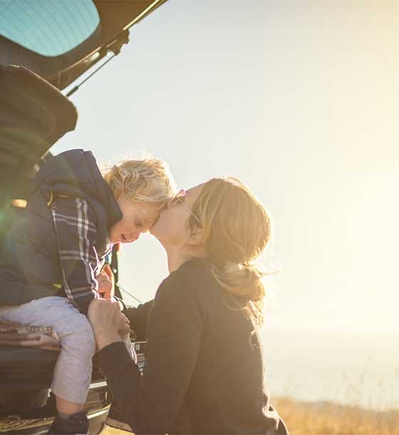 Woman kissing child on forehead