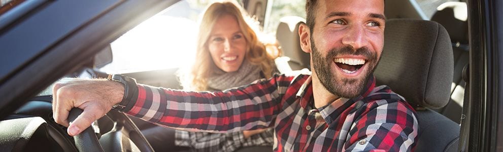 Couple smiling in a car