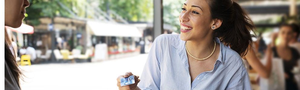 Woman holding debit card