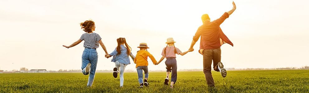 Family running holding hands