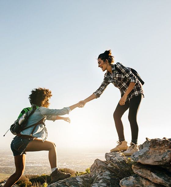 Women climbing a mountain