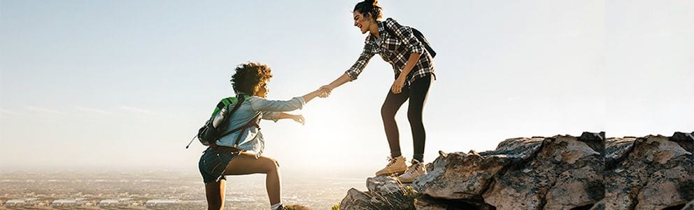 Women climbing a mountain