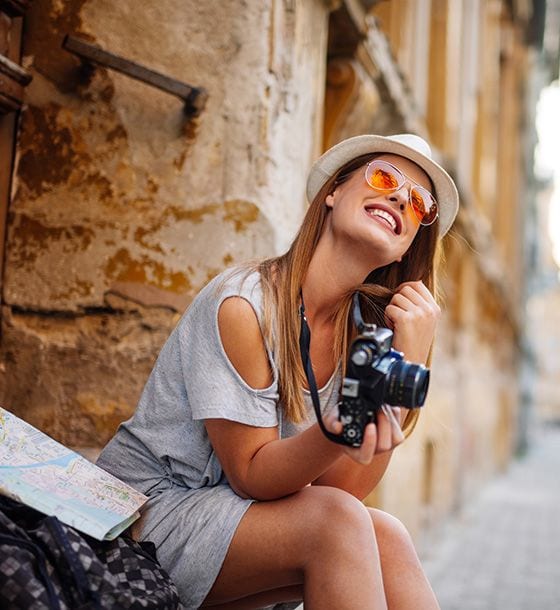 Woman smiling holding camera