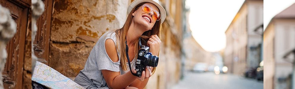 Woman smiling holding camera