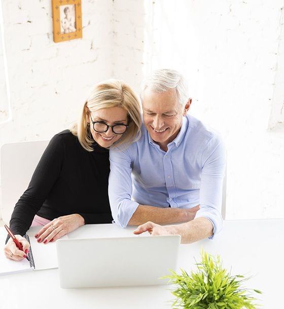 Couple in front of a laptop