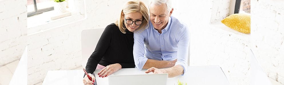 Couple in front of a laptop