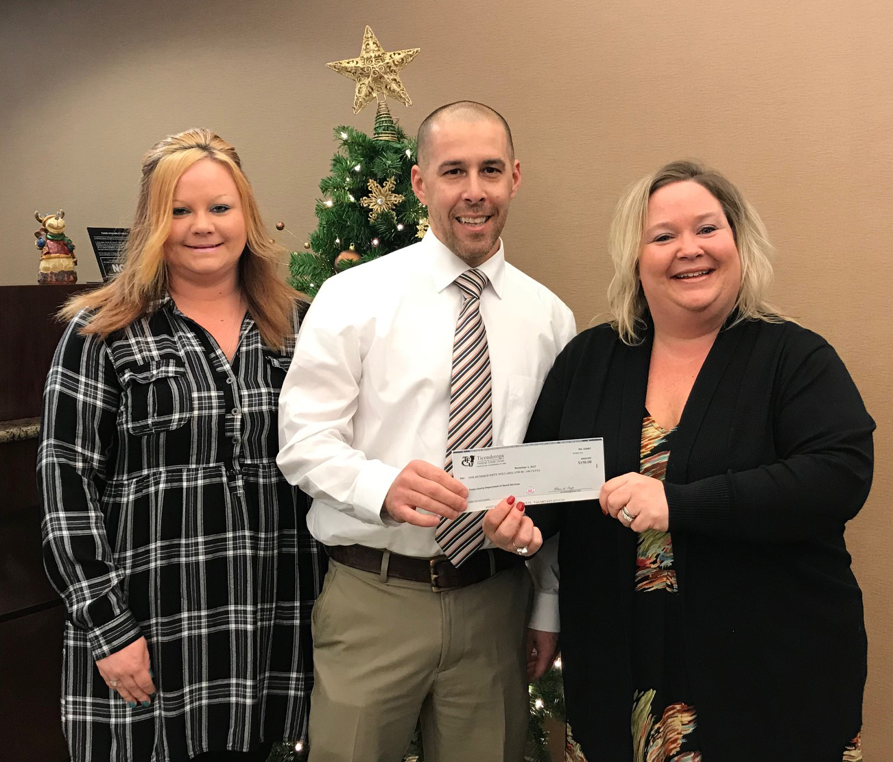 TFCU Member Service representative Shannon Denton and Branch Manager Wendy Courtright presenting TFCU's donation to Mike Mascarenas, Essex County Department of Social Services Commissioner for their annual Toy Drive.