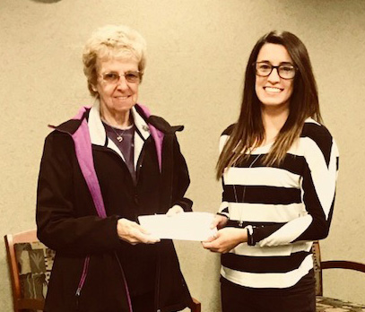 TFCU Member Service representative Deanna Coburn presenting TFCU's donation to Joanne Podres for the Moriah Food Pantry