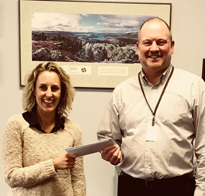 TFCU Marketing Manager, Jennifer Pribble presenting TFCU's donation to Alan Jones, Executive Director/CEO of ACAP for the ACAP Food Shelf in Elizabethtown