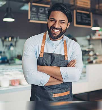 Man in apron laughing