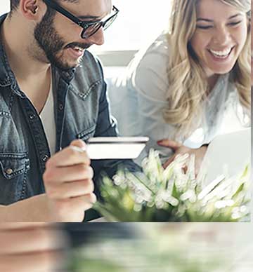 Couple smiling holding credit card