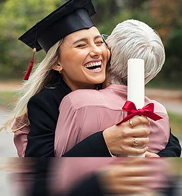 Graduate hugging woman