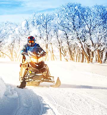 Person riding snowmobile